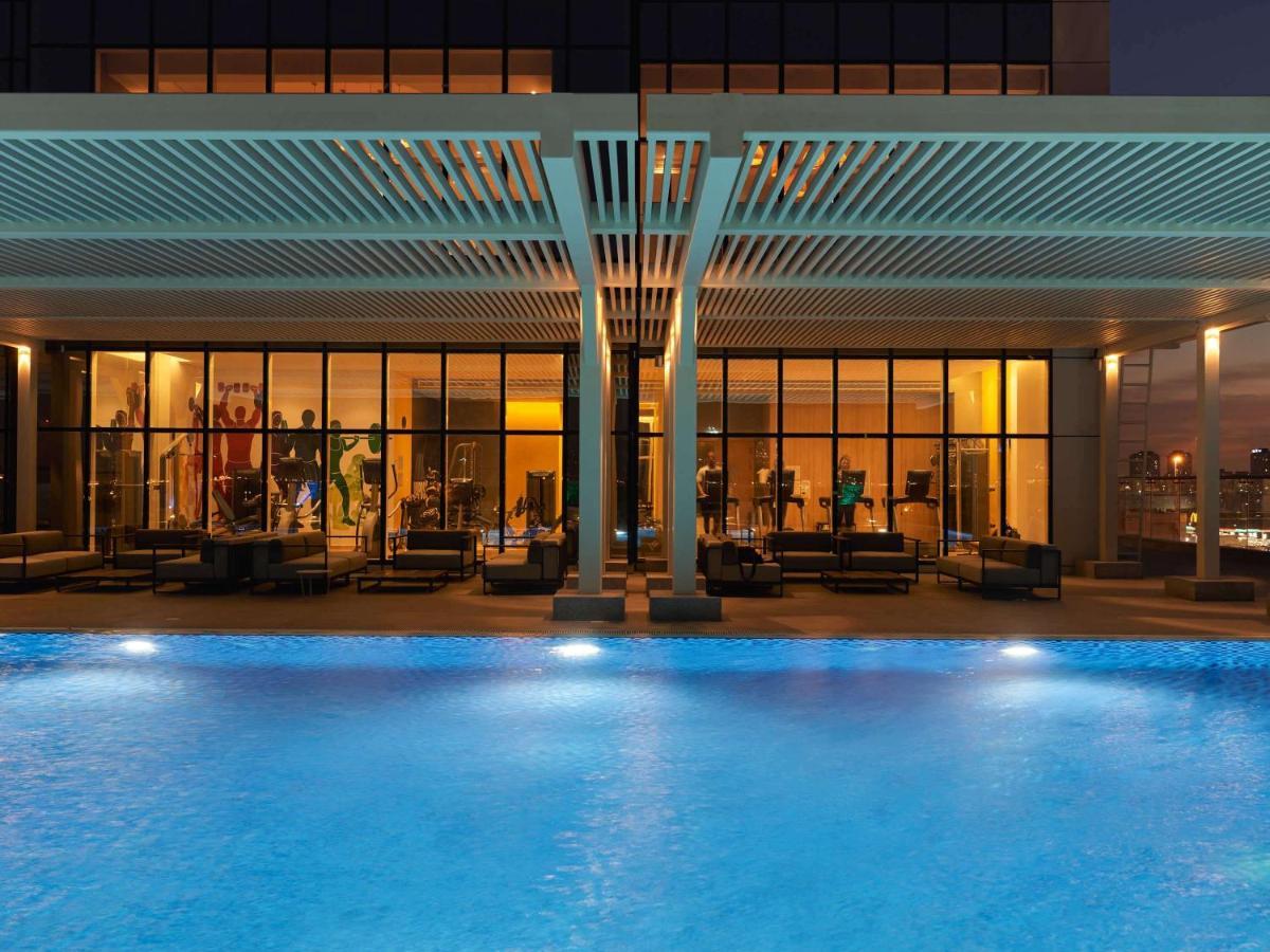 Movenpick Jumeirah Village Triangle Dubai Exterior foto The swimming pool at the hotel